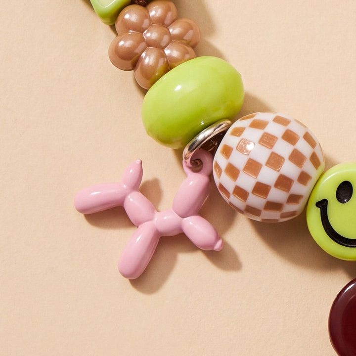 BEADBOO Blush Balloon Dog charm hanging on a handmade beaded dog collar [crop:charm-balloon-dog-blush__hades]