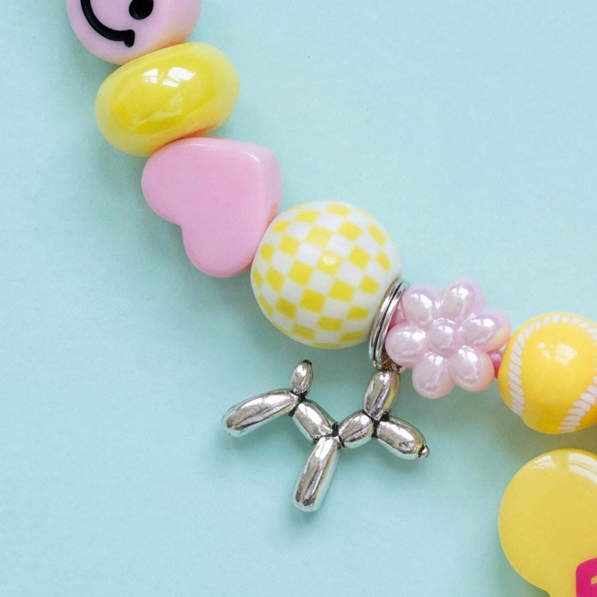 BEADBOO Silver Balloon Dog charm hanging on a handmade beaded dog collar [crop:charm-balloon-dog__frankie]