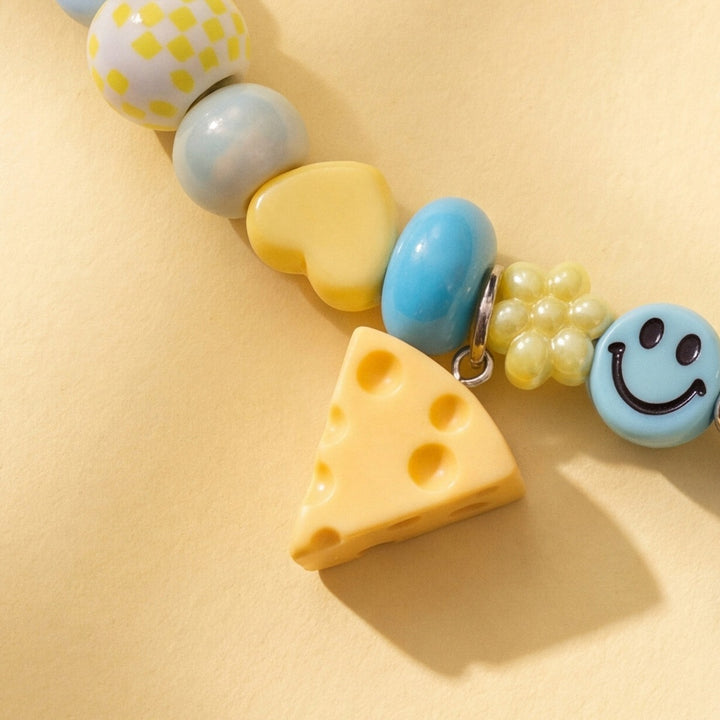 BEADBOO Swiss Cheese charm hanging on a handmade beaded dog collar [crop:charm-cheese__ladybird]