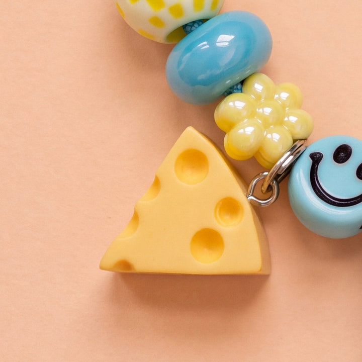 BEADBOO Swiss Cheese charm hanging on a handmade beaded dog collar [crop:charm-cheese__mindy]