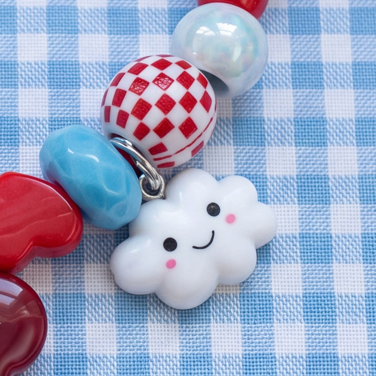 BEADBOO Happy Cloud charm hanging on a handmade beaded dog collar [crop:charm-cloud__louis]