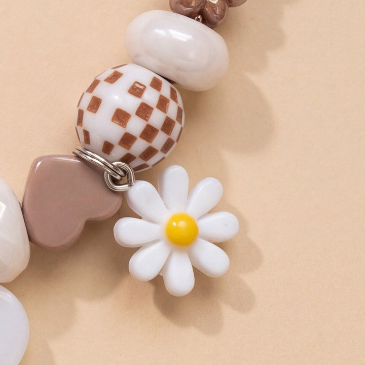 BEADBOO White Daisy charm hanging on a handmade beaded dog collar [crop:charm-flower-white__mavis-rose]