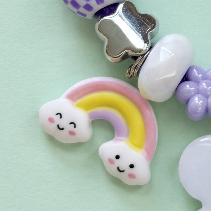 BEADBOO Rainbow charm hanging on a handmade beaded dog collar [crop:charm-rainbow__luna-purple]