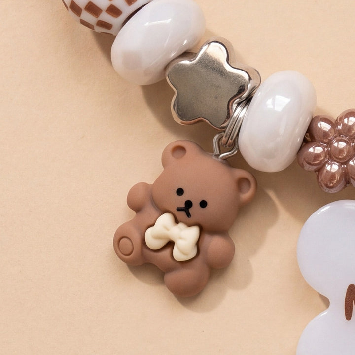 BEADBOO Honey Teddy charm hanging on a handmade beaded dog collar [crop:charm-teddy-bear__mavis-rose]