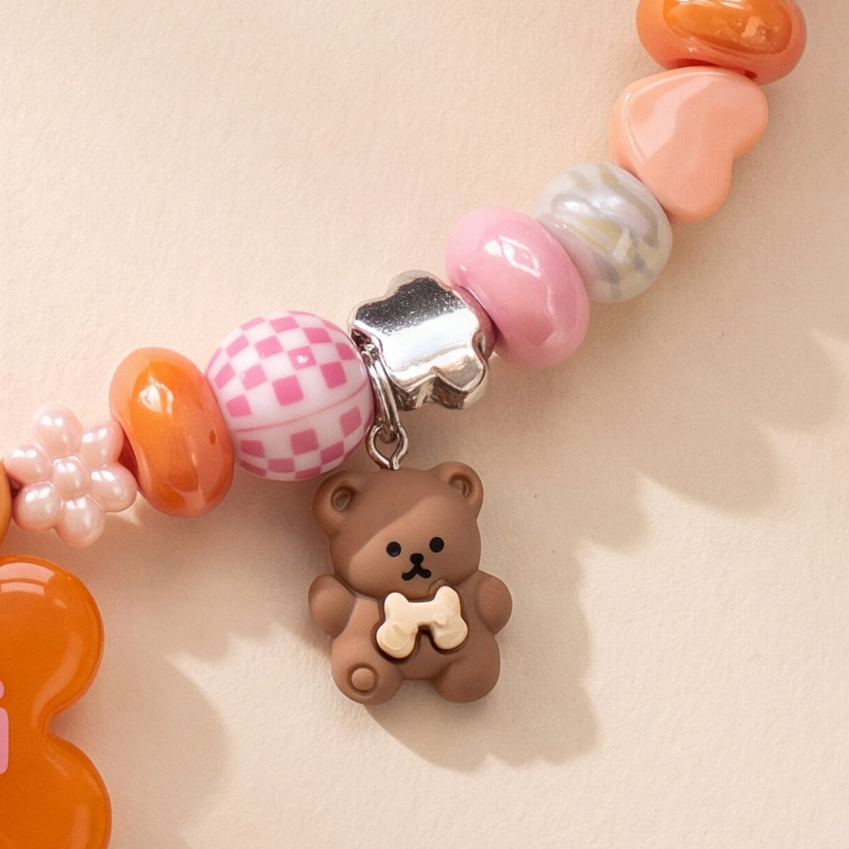 BEADBOO Honey Teddy charm hanging on a handmade beaded dog collar [crop:charm-teddy-bear__mochi]