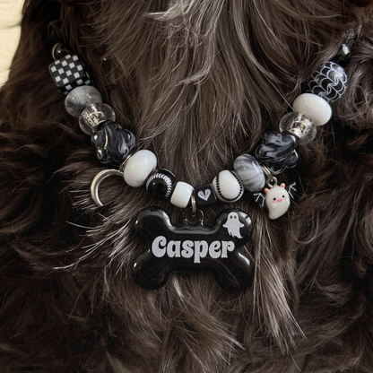 Ghostling beaded dog necklace — black and white beads, silver moon and ghost charms, black bone name tag